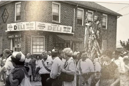 St. Rocco’s Feast was a high point of every July celebrated in honor of the Neapolitan saint. The food, entertainment, and games were legendary. 
Thomas Zuccala in his self-published book, The Way It Was, describes several competitions, “the most challenging contest was trying to climb a pole and reach the top of it to collect the grand prizes of hams, prosciutto, and cash. This was no easy task as the pole was greased and very slippery to climb. Many tried and failed. Some shimmied up carrying sacks of ashes which they put on the pole as they went up. The solution was to tie short pieces of rope around the pole as one rose and thus arrive at the top.”