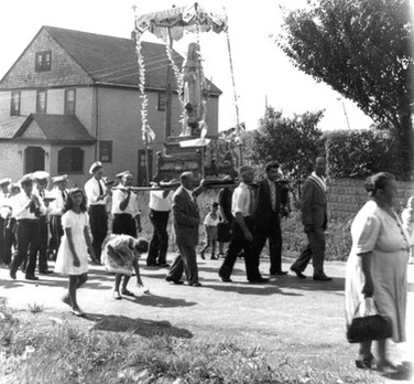 St. Marino’s Feast was celebrated every May in honor of the Calabrese Saint. Hazel St. was festooned with decorations and a bandstand, where for three days, music, processions, and fireworks were featured.

DeLuccas, who owned a bar on Hazel Street, would launch helium balloons bearing St. Marino’s image when the procession passed his business.

This picture dated 1933 shows the statue of St. Marino was carried by devotees from Dominick Bellissimo’s house on First Street through the neighborhood before arriving at her permanent home in St. Rocco’s Church.